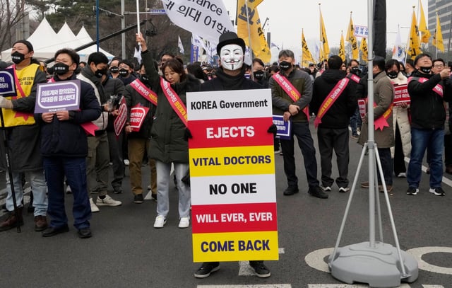 Doctors wearing masks attend a rally against the government’s medical policy in Seoul, South Korea. Photo: AP