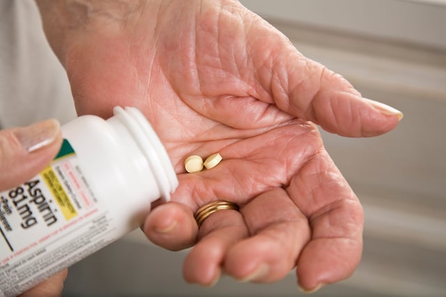 senior woman taking asprin