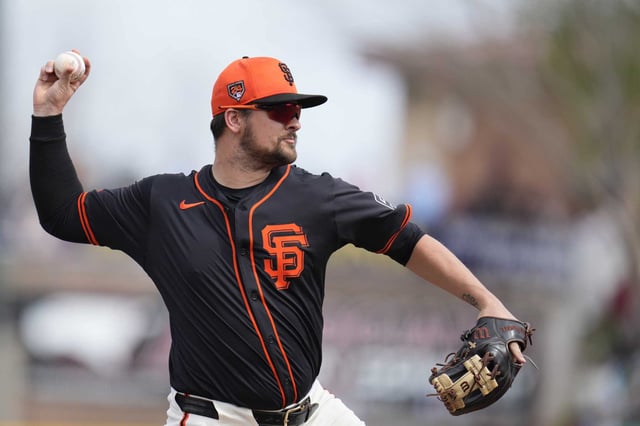 San Francisco Giants third baseman J.D. Davis warms up prior to a spring training baseball game against the Chicago Cubs Saturday, Feb. 24, 2024, in Scottsdale, Ariz. (AP Photo/Ross D. Franklin)