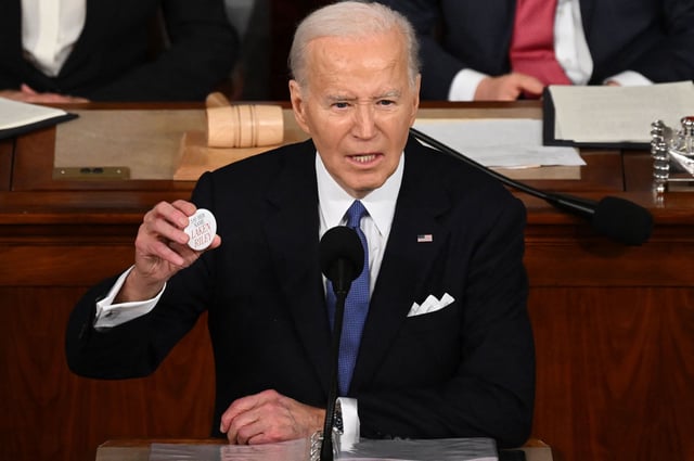 US President Joe Biden holds a "Say her name Laken Riley" button while delivering the State of the Union address in the House Chamber of the US Capitol in Washington, DC, on March 7, 2024. (Photo by SAUL LOEB / AFP) (Photo by SAUL LOEB/AFP via Getty Images)