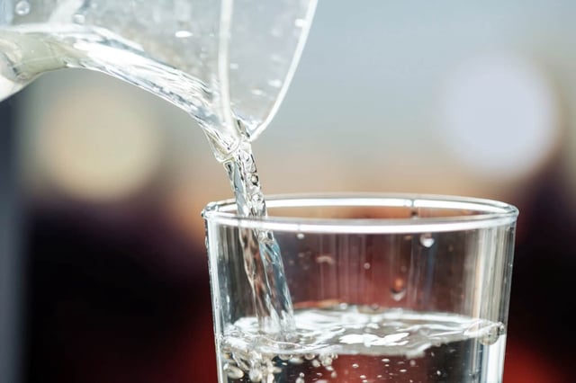 pouring water into a glass