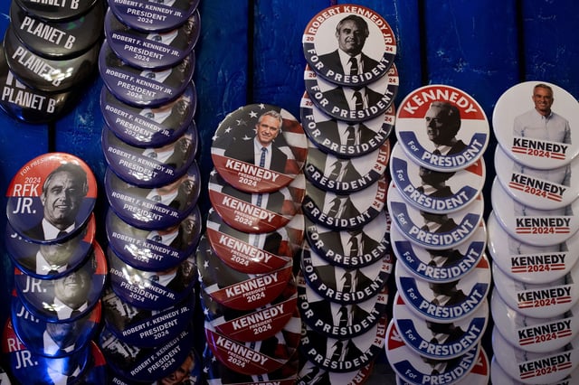 Pins and other merchandise in support of Independent presidential candidate Robert F. Kennedy Jr. on display during a voter rally at St. Cecilia Music Center on February 10 in Grand Rapids, Michigan.