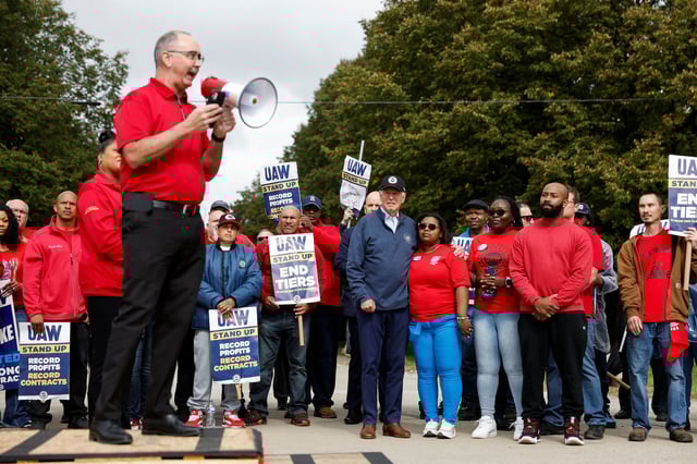Shawn Fain, president of the United Auto Workers, speaks as Biden joins striking members of the United Auto Workers on the picket line outside the GM's Willow Run Distribution Center, in Belleville, Michigan, in September 2023.