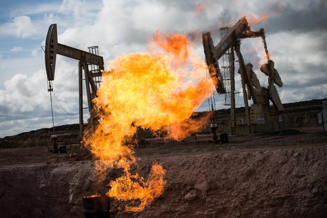 A gas flare is seen at an oil well site outside Williston, North Dakota.