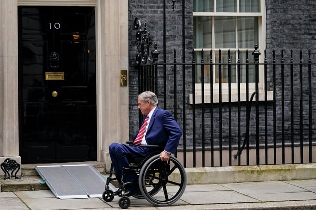Texas Gov. Greg Abbott arrives for a meeting Wednesday with Britain’s Business Secretary Kemi Badenoch in 10 Downing Street in London. They signed a trade and economic development arrangement, the eighth and largest state-level arrangement signed by the U.K. with an individual U.S. state, benefiting emerging energy solutions, life sciences, infrastructure and professional business services.