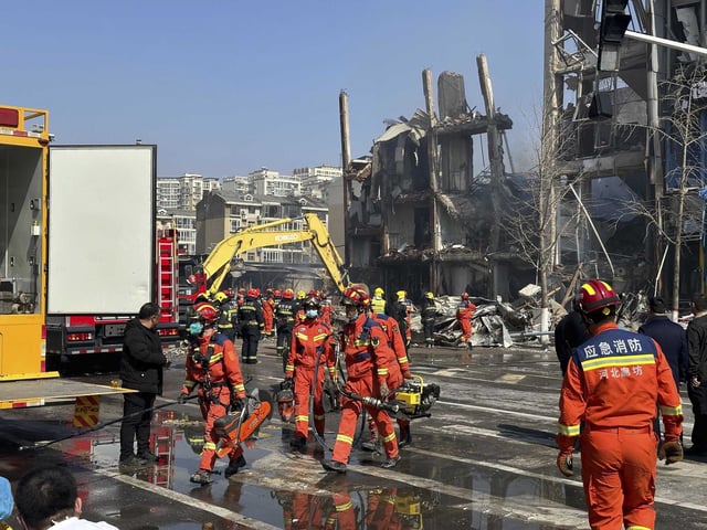 FILE - Firefighters work the scene of an explosion in Sanhe city in northern China's Hebei province on Wednesday, March 13, 2024. The city of Sanhe, near Beijing, issued a public apology Thursday, March 14, after authorities were shown harassing reporters from state broadcaster CCTV during a live broadcast near the site of a suspected gas leak explosion that killed several and injured more than 20 on Wednesday.