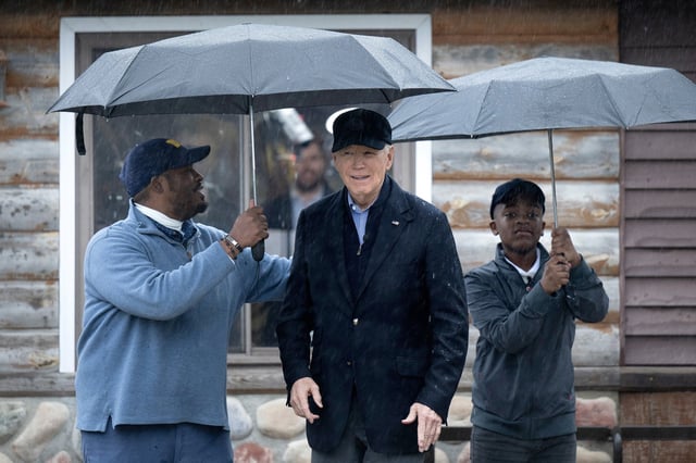 President Joe Biden is greeted by Hurley Coleman III, from left, and Hurley Coleman IV, from right, while arriving for a campaign event with supporters at Pleasant View Golf Course in Saginaw, Mich., on March 14, 2024.