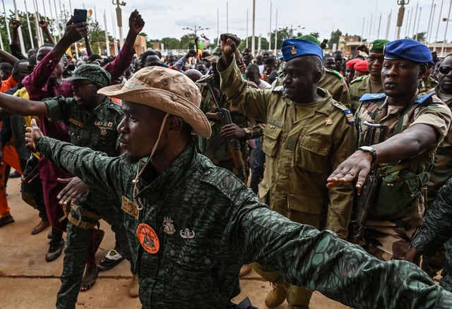Niger's National Council for the Safeguard of the Homeland Colonel-Major Amadou Abdramane, second from right, is greeted by supporters upon his arrival at the Stade General Seyni Kountche in Niamey on August 6, 2023.