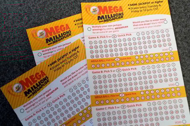 Mega Millions playslips are seen on a counter at a convenience store Tuesday, Jan. 3, 2023, in Northbrook, Ill.