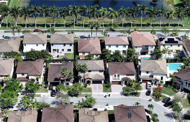 In an aerial view, homes sit on lots in a residential neighborhood on March 15, 2024, in Miami, Florida. The National Association of Realtors announced that it had reached a nationwide settlement of claims that the industry had conspired to keep agent commissions high. As part of the settlement, the National Association of Realtors did not admit wrongdoing but agreed to pay $418 million over the next four years.