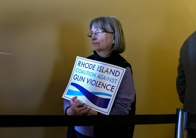 Gun opponent Susan Feeley of Providence waits in line with others to enter the Senate Judiciary hearings on a variety of gun bills at the RI State House last Tuesday.