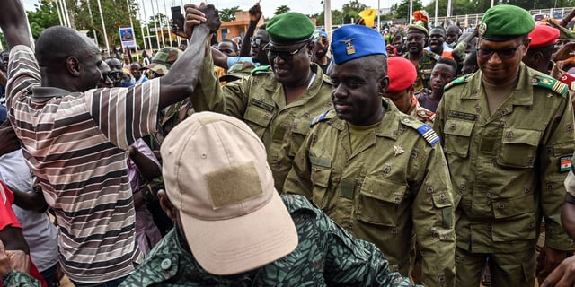 Col. Maj. Amadou Abdramane (center), Gen. Mohamed Toumba (center left), and Col. Ousmane Abarchi (right) are greeted by supporters upon their arrival at the Gen. Seyni Kountche Stadium in Niamey, Niger, on Aug. 6, 2023.