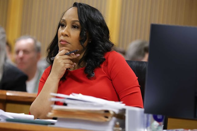 FILE - Fulton County District Attorney Fani Willis looks on during a hearing on the Georgia election interference case, Friday, March, 1, 2024, in Atlanta. A progressive Democrat and a Republican who briefly worked in Donald Trump's administration entered the Fulton County district attorney's race Friday, March 8, 2024, as the current officeholder, Willis, awaits a judge's decision on whether she will be removed from the Georgia election interference case against the former president.