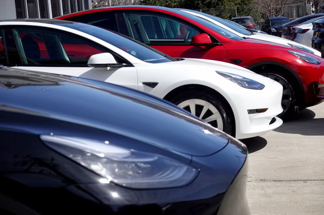 Tesla cars sit in a dealership lot in Chicago, Illinois.