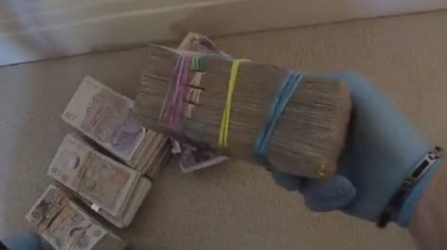 Piles of cash discovered during police searches connected to Wen Jian.
