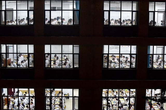 This photo taken on May 17, 2023 shows high school students going through exam papers, ahead of the National College Entrance Examination (NCEE), known as "gaokao", in Handan, in China's northern Hebei province.