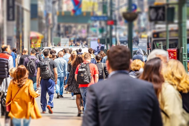 USA, New York, Manhattan streets. Skyscrapers and crowded streets, cars and busy people walking downtown in a spring sunny day