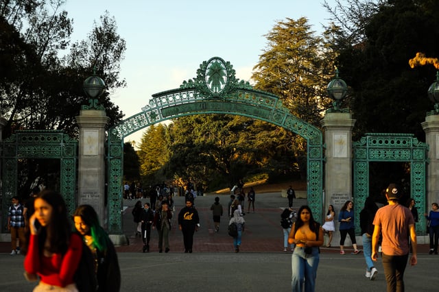 Student pass through Sather Gate on the UC Berkeley campus on Friday, February 18, 2022, in Berkeley, Calif.