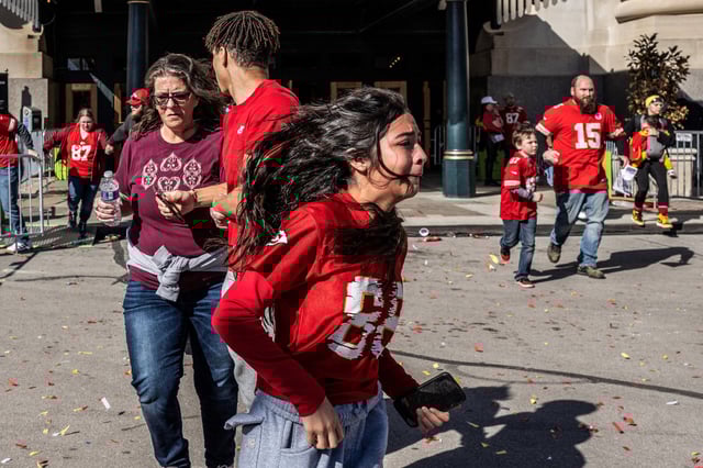 People flee after shots were fired near the Kansas City Chiefs' Super Bowl LVIII victory parade on Feb. 14, 2024, in Kansas City, Mo.