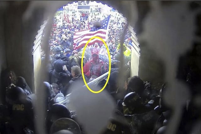 This image from police body-worn video and contained in the Justice Department statement of facts supporting the arrest of Rally Runner, shows Rally Runner outside the U.S. Capitol on Jan. 6, 2021, in Washington. Rally Runner, who legally changed his name from Daniel Donnelly Jr., pleaded guilty on Friday, March 22, 2024, to a felony charge of civil disorder and is scheduled to be sentenced in July. (Department of Justice via AP)