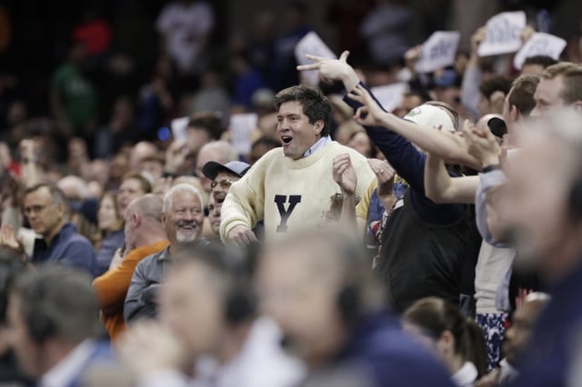 A Yale fan, cdnter, cheers during the second half of a first-round college basketball game against Auburn in the NCAA Tournament in Spokane, Wash., Friday, March 22, 2024. (AP Photo/Young Kwak)