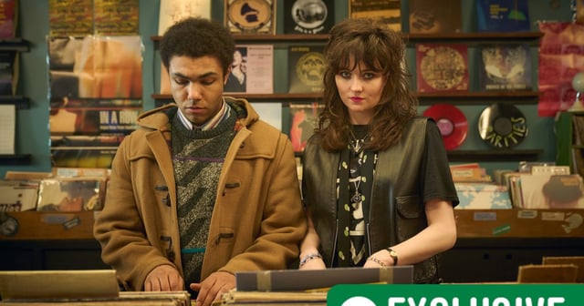 Levi Brown as Dante Williams and Freya Parks as Fiona in This Town standing together in a record shop. RT Exclusive is in the bottom right of the frame