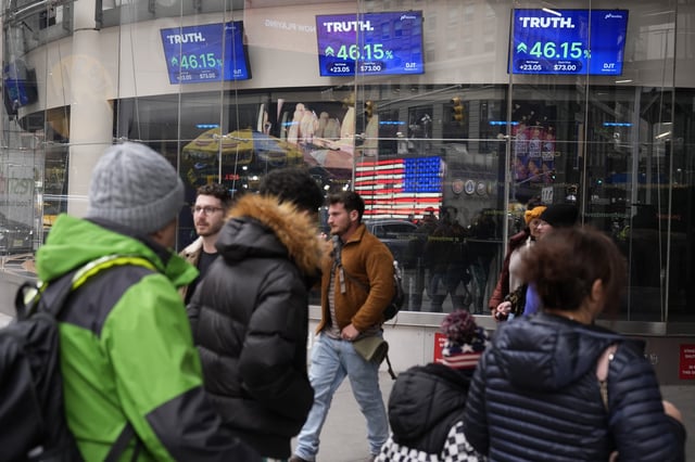 Pedestrians walk past the Nasdaq building Tuesday, March 26, 2024, in New York. Trump Media, which runs the social media platform Truth Social, now takes Digital World's place on the Nasdaq stock exchange.