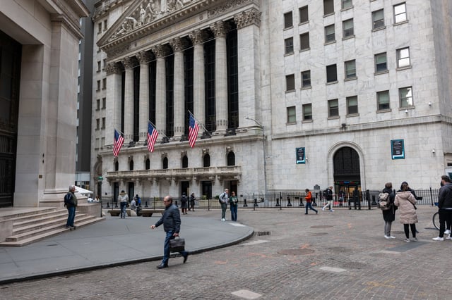 People walk by the New York Stock Exchange (NYSE) on March 20, 2024 in New York City.