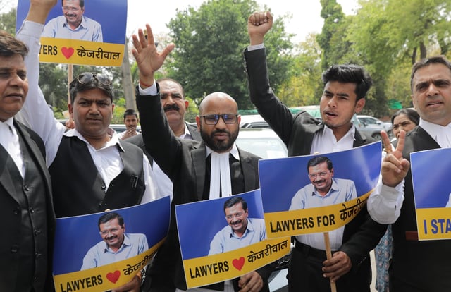 Indian lawyers shout slogans and hold placards showing the Delhi Chief Minister Arvind Kejriwal during a protest against Kejriwal’s arrest in New Delhi on March 27. Photo: EPA-EFE