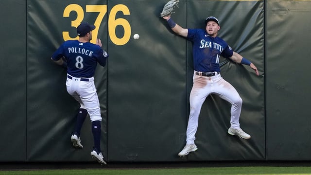 Seattle Mariners left fielder AJ Pollock (8) and center fielder Jarred Kelenic, right, can't come up with triple by Minnesota Twins' Alex Kirilloff during the fourth inning of a baseball game Tuesday, July 18, 2023, in Seattle. (AP Photo/Lindsey Wasson)