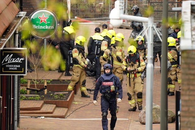 Police and emergency services are seen amid the hostage incident in Ede on Saturday.