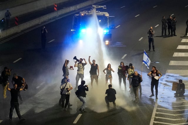Police use water cannon to disperse demonstrators from a highway in Tel Aviv on March 30. Photo: AP
