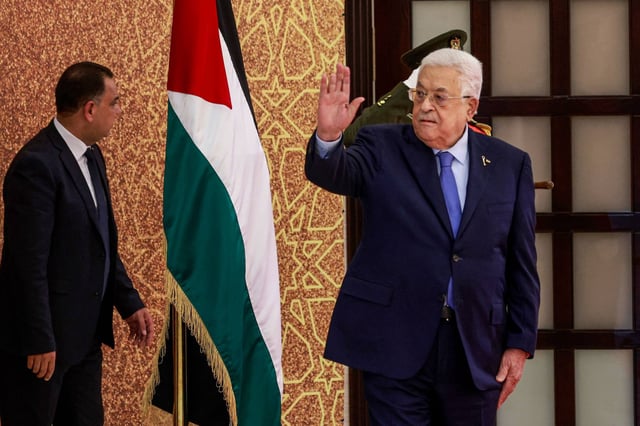Palestinian Authority President Mahmoud Abbas waves during a swearing-in ceremony of newly appointed ministers on Sunday in Ramallah, occupied West Bank. Photo: AFP