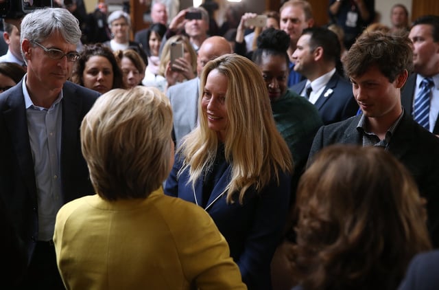 Reed Jobs and his mother Laurene Powell Jobs greet Hillary Clinton.