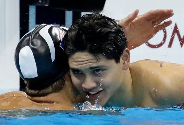 Joseph Schooling (right) is congratulated by Michael Phelps after beating the American in Rio. Photo: AP