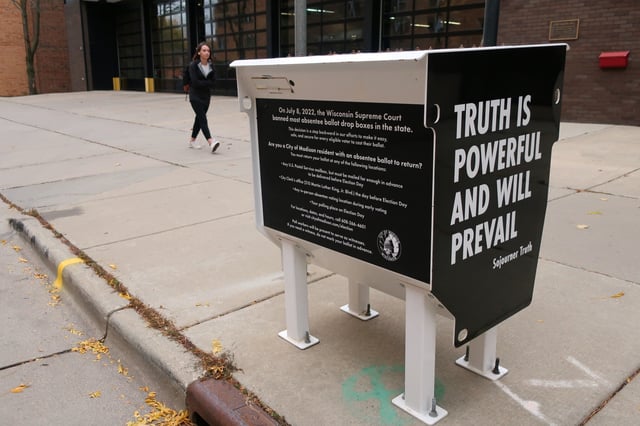 A former absentee ballot drop box has been transformed into a pro-democracy piece of art, Oct. 25, 2022, in Madison, Wis. Democratic Gov. Tony Evers urged the Wisconsin Supreme Court on Tuesday, April 2, 2024, to overturn a ruling that banned absentee ballot drop boxes in the presidential battleground state. (AP Photo/Scott Bauer, File)