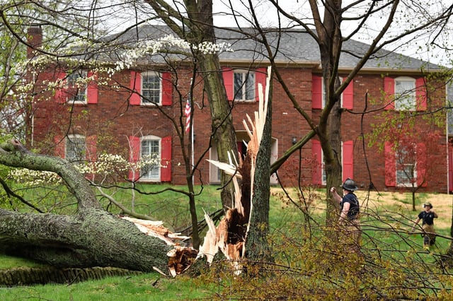 Firefighters with the Anchorage Middletown Fire Department check houses for gas leaks following severe storms that passed through Prospect, Ky., Tuesday, April 2, 2024. (AP Photo/Timothy D. Easley)