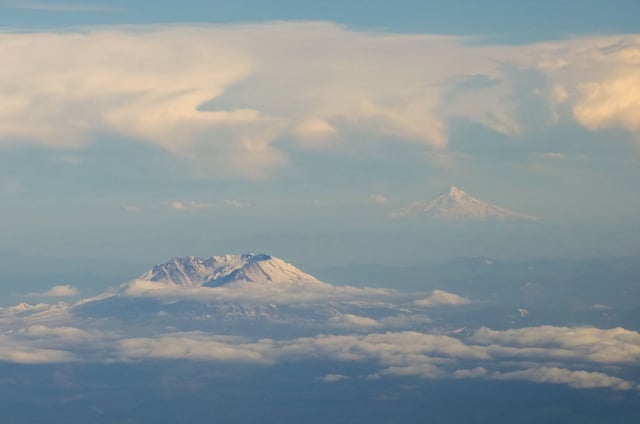 Mount St. Helens, at left, and Mount Hood, right, are seen Thursday, May 18, 2023, from Lewis County, Wash. (AP Photo/Lindsey Wasson)