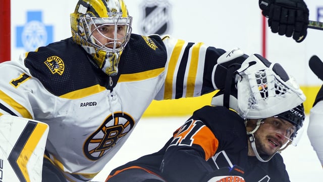 FILE - Boston Bruins' Jeremy Swayman, left, pushes Philadelphia Flyers' Scott Laughton, right, away during an NHL hockey game, Sunday, April 9, 2023, in Philadelphia. Boston Bruins goaltender Jeremy Swayman has been awarded $3.475 million through arbitration on a contract for next season, the team announced. A judge passed down his ruling Tuesday, Aug. 1, 2023 after a hearing Sunday. (AP Photo/Chris Szagola, File)