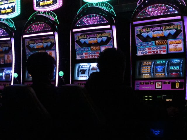 This March 9, 2016 photo shows gamblers playing slot machines at the Tropicana casino in Atlantic City, N.J.