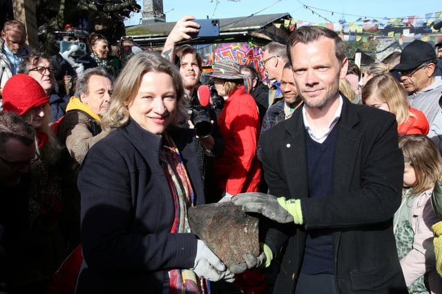 Mayor of Copenhagen Sophie Haestorp Andersen and Danish Justice Minister Peter Hummelgaard hold a cobble stone removed by residents from the area of Freetown Christiania known as the "Pusher Street" on Saturday.