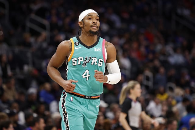 Devonte' Graham #4 of the San Antonio Spurs runs to the bench in the second half of a game against the Detroit Pistons at Little Caesars Arena on February 10, 2023 in Detroit, Michigan.