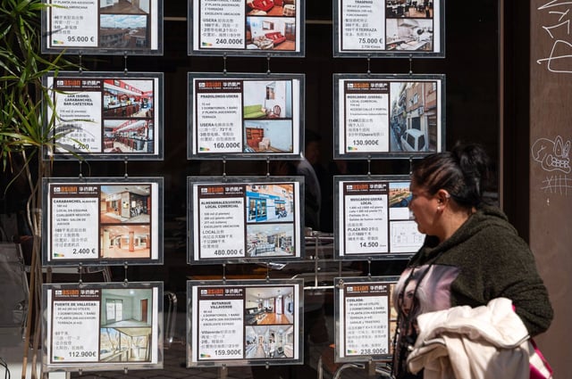Sales advertisements at a Madrid real estate agency offering property services in Chinese language. Photo: Bloomberg