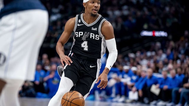 FILE - San Antonio Spurs guard Devonte' Graham (4) dribbles towards the basket in the first half of an NBA basketball game against the Dallas Mavericks, Feb. 23, 2023, in Dallas. The NBA has suspended Graham for two games without pay after he pleaded guilty to driving while intoxicated, the league announced Tuesday, Aug. 1, 2023. (AP Photo/Emil T. Lippe, File)