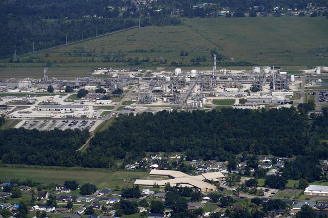 FILE - The Fifth Ward Elementary School and residential neighborhoods sit near the Denka Performance Elastomer Plant, back, in Reserve, La., Sept. 23, 2022. In what could prove a significant move for communities facing air pollution, the Environmental Protection Agency proposed on Thursday, April 6, 2023, that chemical plants nationwide measure certain hazardous compounds that cross beyond their property lines and reduce them when they are too high. (AP Photo/Gerald Herbert, File)