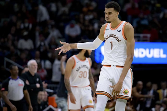 San Antonio Spurs center Victor Wembanyama (1) celebrates after a 3-point basket during the second half of an NBA basketball game against the New Orleans Pelicans in New Orleans, Friday, April 5, 2024. (AP Photo/Matthew Hinton)