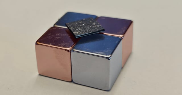 The silica-coated graphite plate levitates above a magnetic surface, with no need for external power