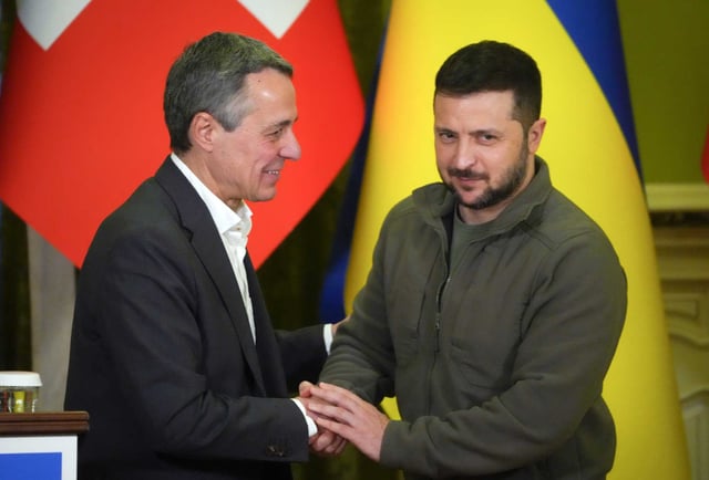 FILE - Ukrainian President Volodymyr Zelenskyy, right, shakes hands with Swiss President Ignazio Cassis in Kyiv, Ukraine, on Oct. 20, 2022. Switzerland's government said Wednesday April 10, 2024 it will host a high-level international conference in June to help chart a path toward peace in Ukraine after more than two years of war, in hopes that Russia might join in the peace process one day.