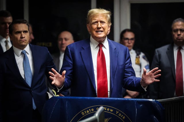 Former President Donald Trump speaks to the press in a hallway outside the courtroom at Manhattan Criminal Court in New York on March 25, 2024.