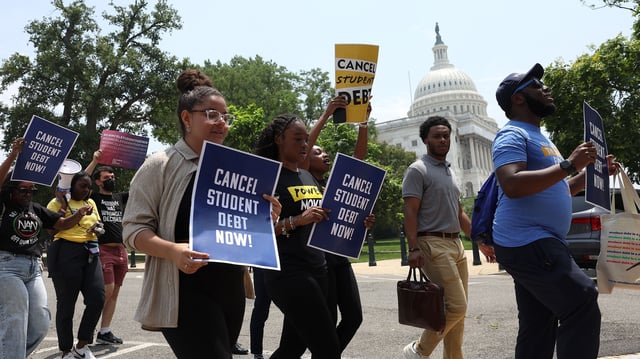 Student debt relief activists participate in a rally as they march from the US Supreme Court to the White House on June 30, 2023 in Washington, DC.